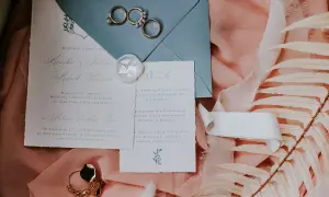 Eleganckie zaproszenie ślubne z imionami Moniki i Marka, pierścionki i pieczęć. Jak wypisać zaproszenie z dzieckiem?