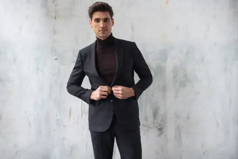 Elegancki mężczyzna w garniturze i golfie. Nowoczesne męskie style ubioru.